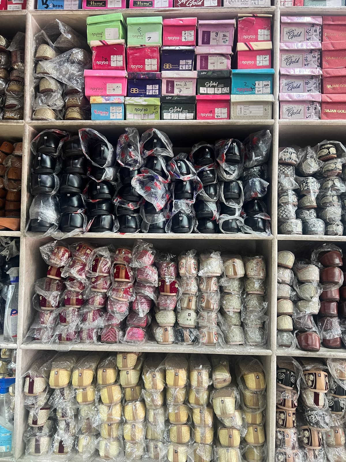 Colour-sorted juttis filling a shelving bay